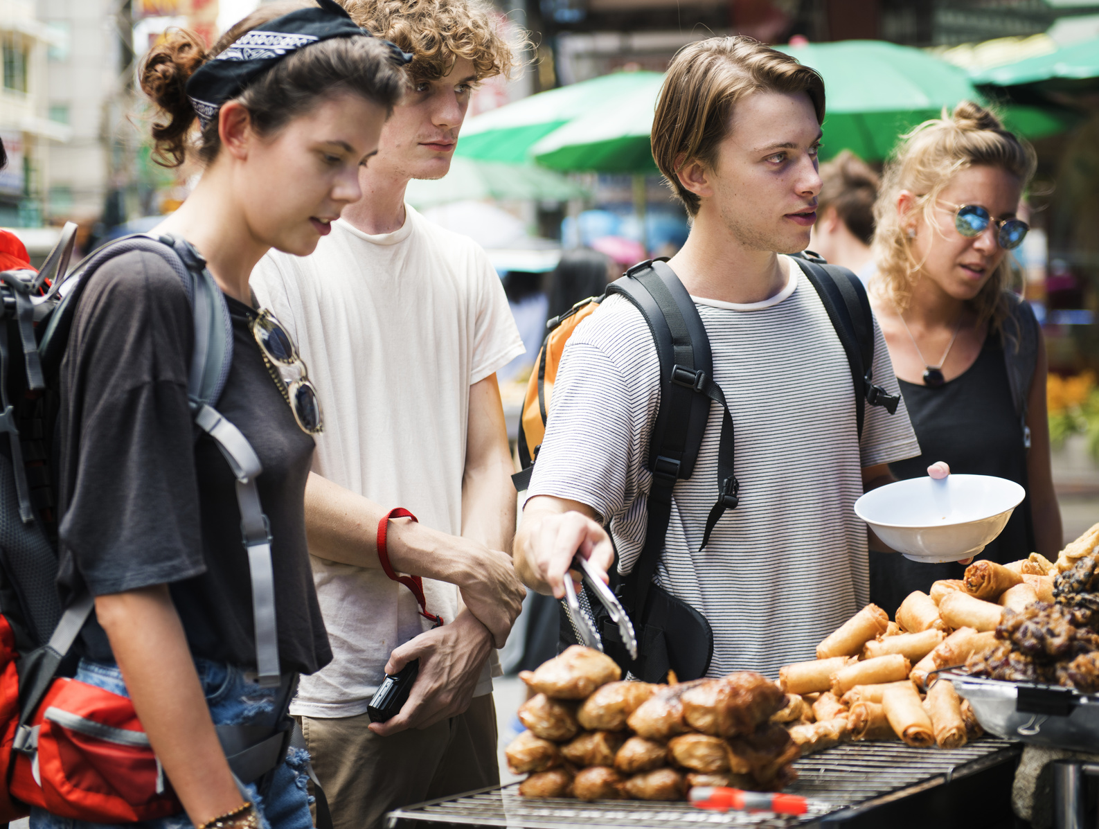 A group of tourists buying Thai Food at food stall