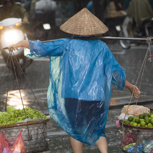 woman in rain poncho - hanoi